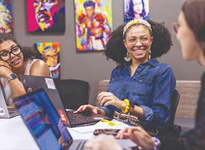 three women smiling and talking together
