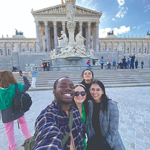 group of students taking a selfie in front of a famous monument