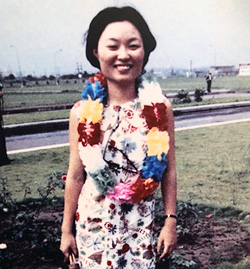 Phylis Lan Lin as a young lady arriving with lei around her neck