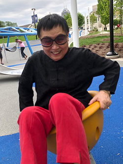 Dr. Lin laughing in a playground area