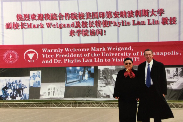 Dr. Lin with Mark Weigand, large banner welcoming him