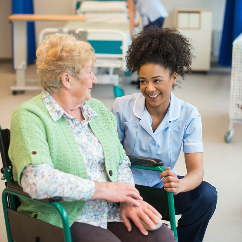 senior woman with younger woman in hospital