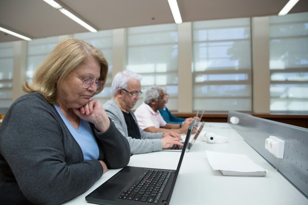 older adults learning on laptops