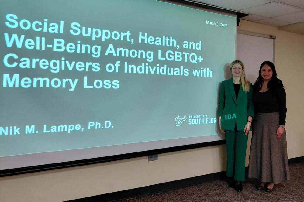 two people standing next to a presentation