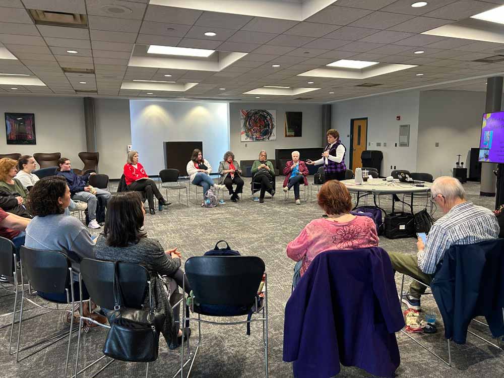 woman talking to a large group of seniors