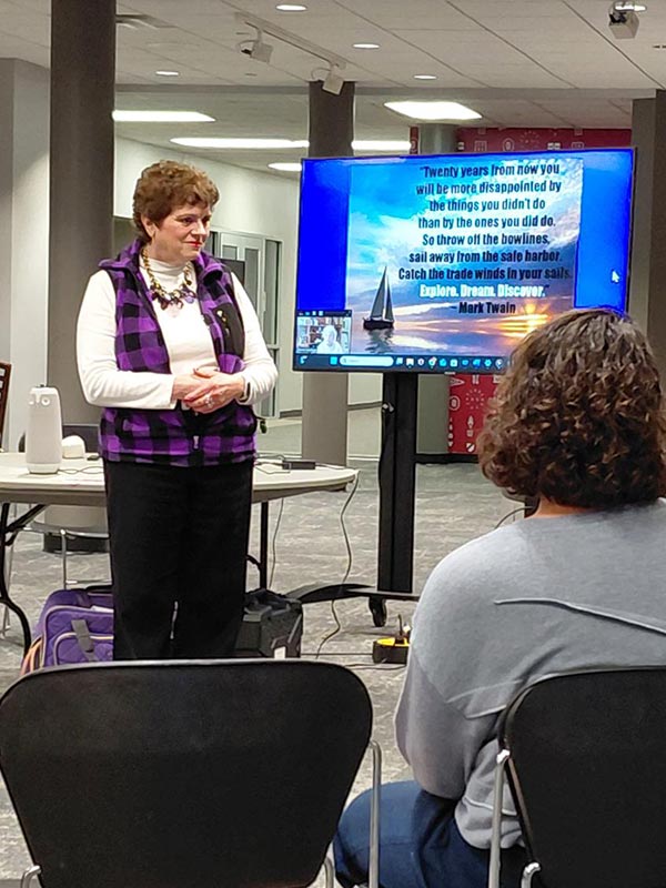 woman standing in front of a TV display