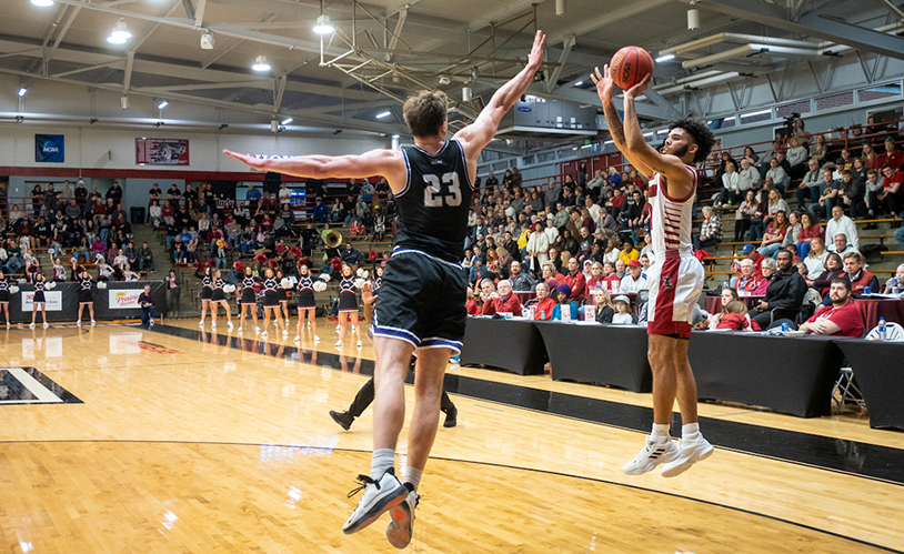 UIndy basketball player jumping to shoot the ball