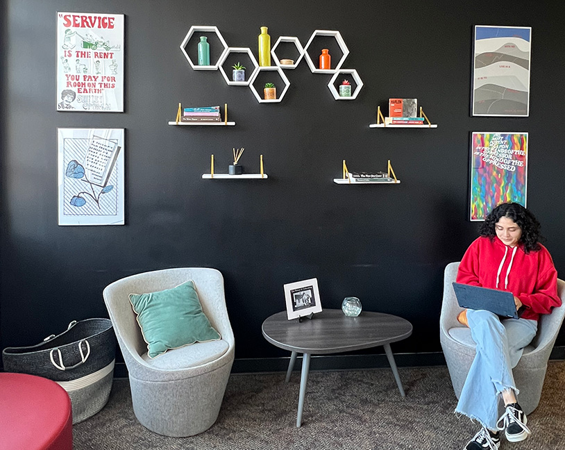 lady sitting in from an art wall