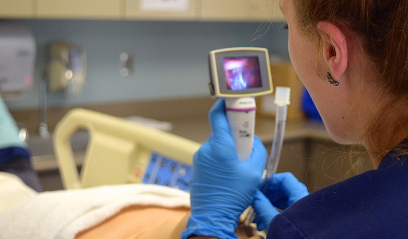 respiratory therapist using equipment in a lab