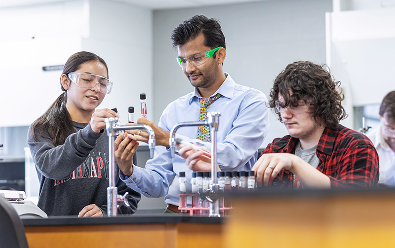 teacher and students working together in the lab