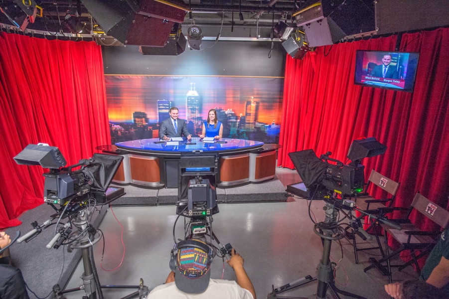 students at the UIndy TV news anchor desk