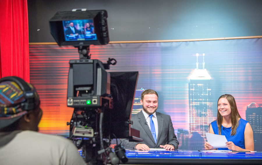 students in front of a camera in the tv studio