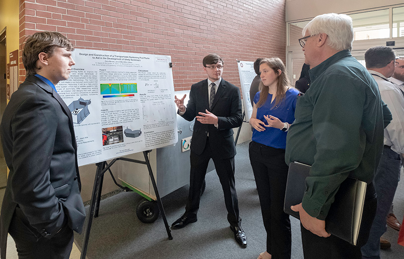 students presenting their poster project