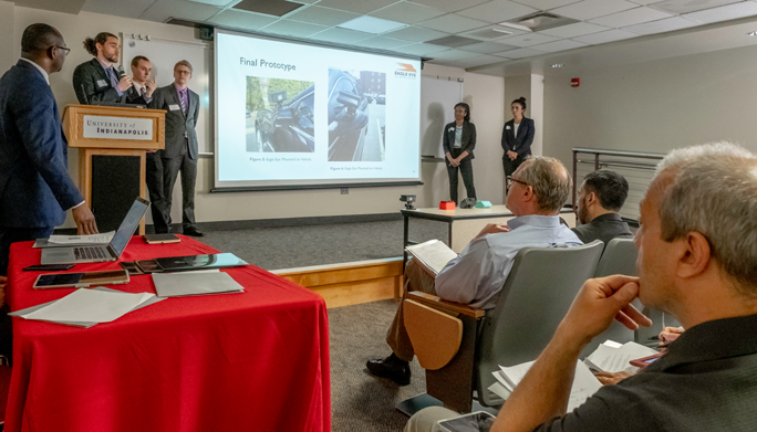 students in business clothes presenting their project at the Engineering Business Pitch Competition