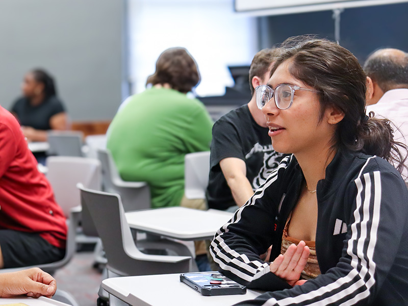 student talking in class during a group activity