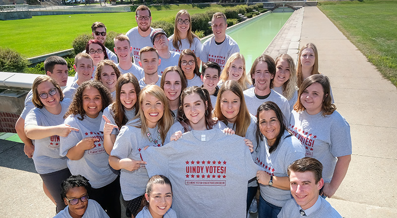group of students and staff wearing UIndy Votes t-shirt