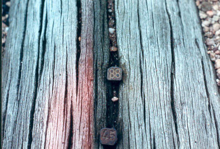 two nail heads, numbered 88 and 45