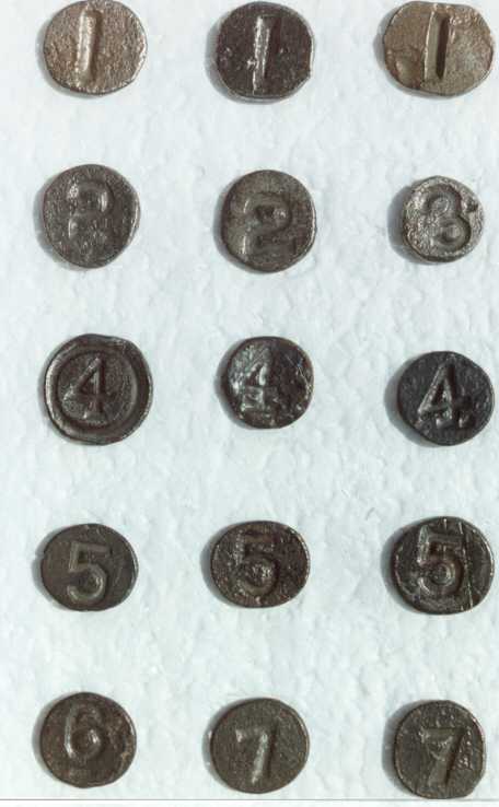 15 nail heads with multiples numbered 1 through 7