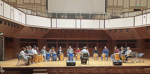 group of people on stage playing percussion instruments