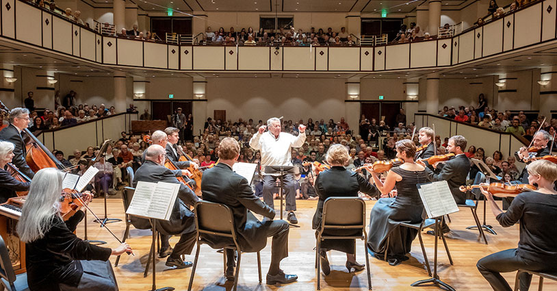 Maestro Raymond Leppard conducting an orchestra