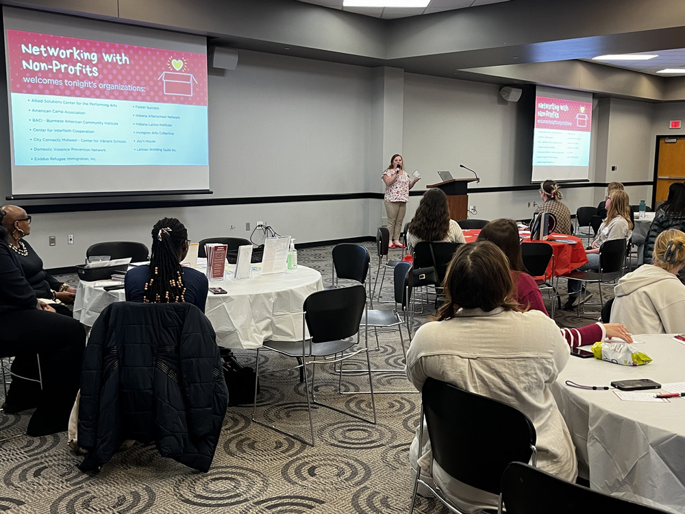 students networking with nonprofit representatives at tables