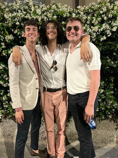 Cordale and his friends in front of a flower wall in Italy.