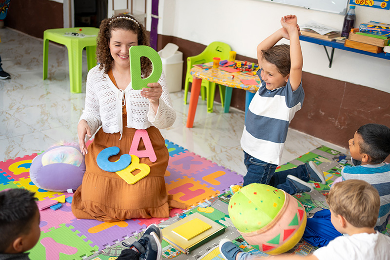 kids playing a letter activity with instructor