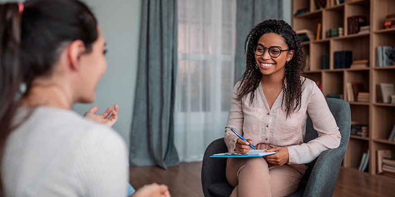 a counselor is smiling at a client