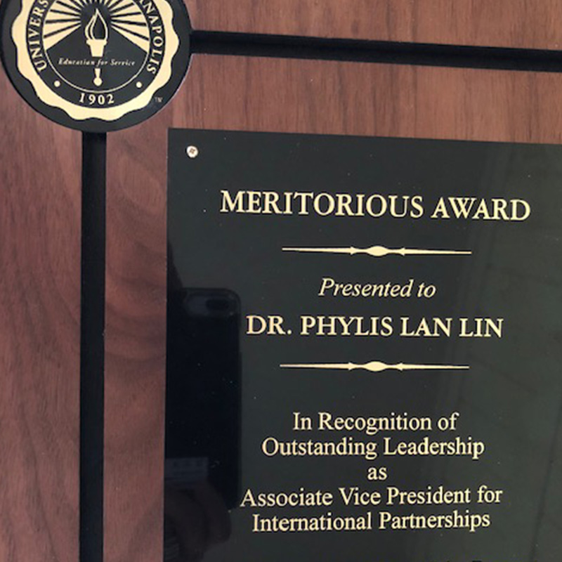 meritorious plaque with Dr. Lin's name in recognition of outstanding leadership