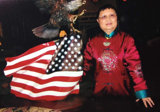 Dr. Phylis Lan Lin with U.S. flag statue