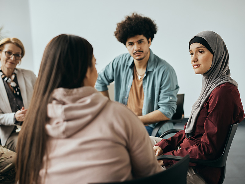 group of four people in discussion