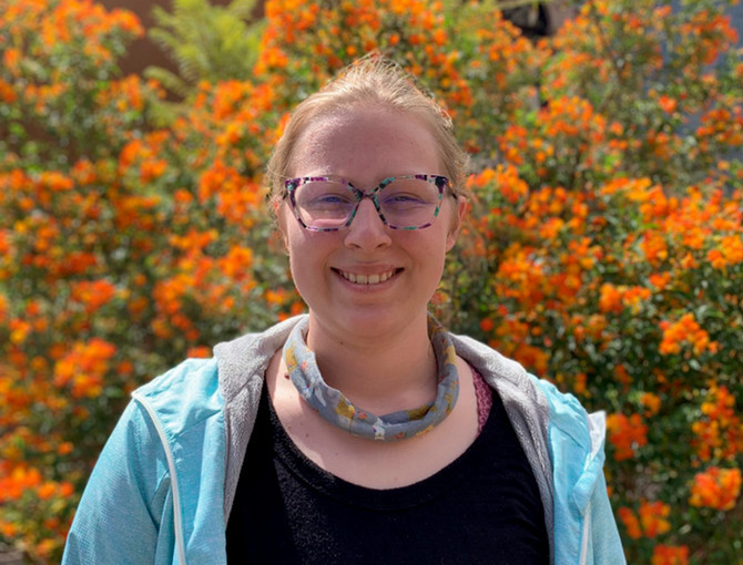 young lady with glasses, smiling
