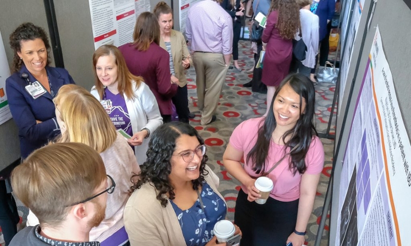 Students & faculty discuss poster presentations.