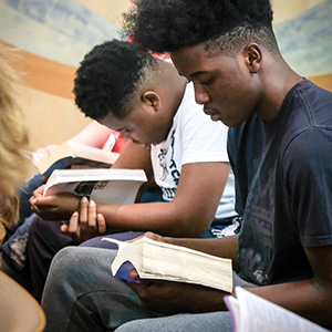 students concentrating on a book