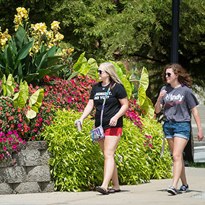 students walking by flowers