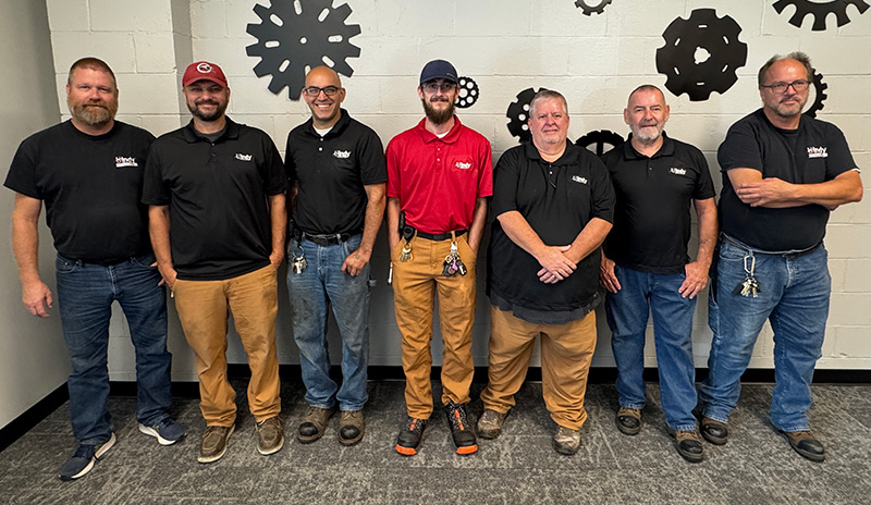 group of 7 men standing in a line