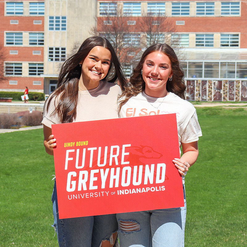 two girls holding "future greyhound" sign