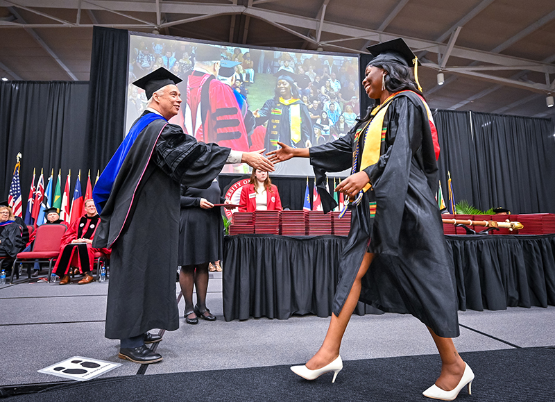 Student receives diploma at commencement
