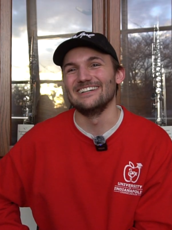 Casey Adams sitting outside of Esch Hall