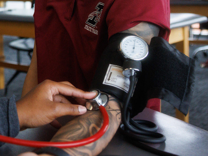 a person is getting their blood pressure checked