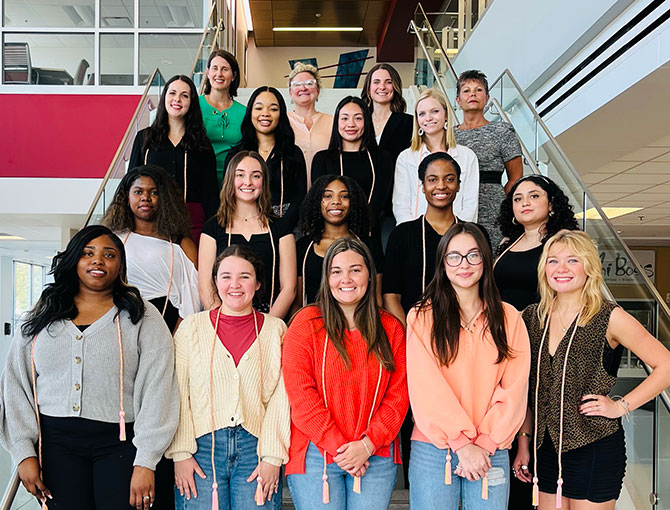large group of students and professors standing on the stairs