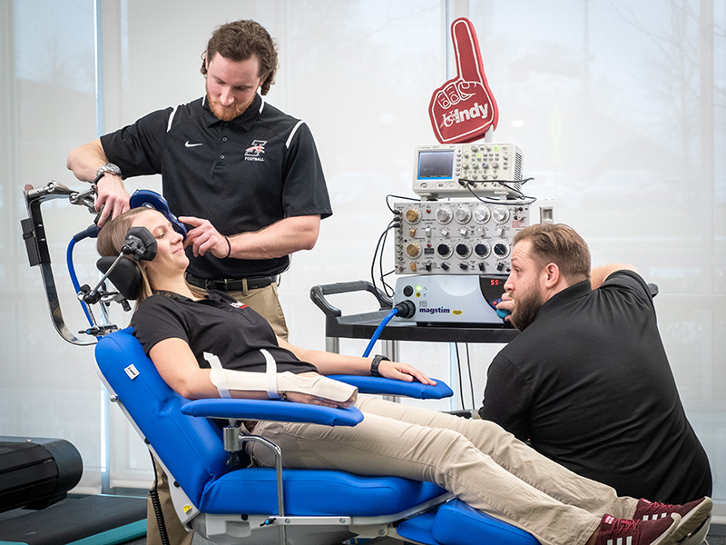 graduate students are using equipment in the motion lab