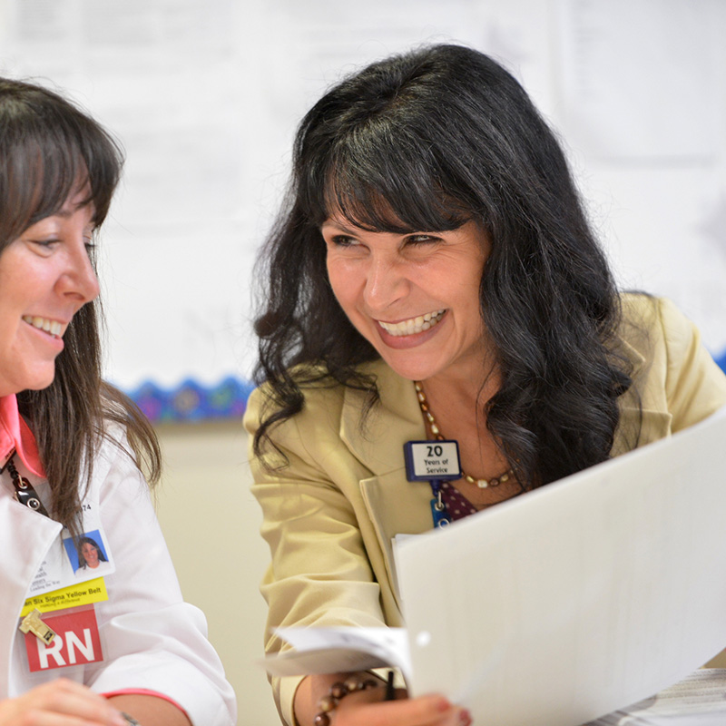 two nurses look at documents together
