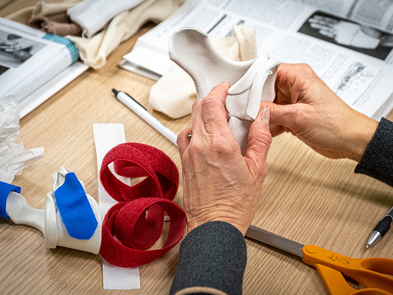 a pair of hands holding a hand splint