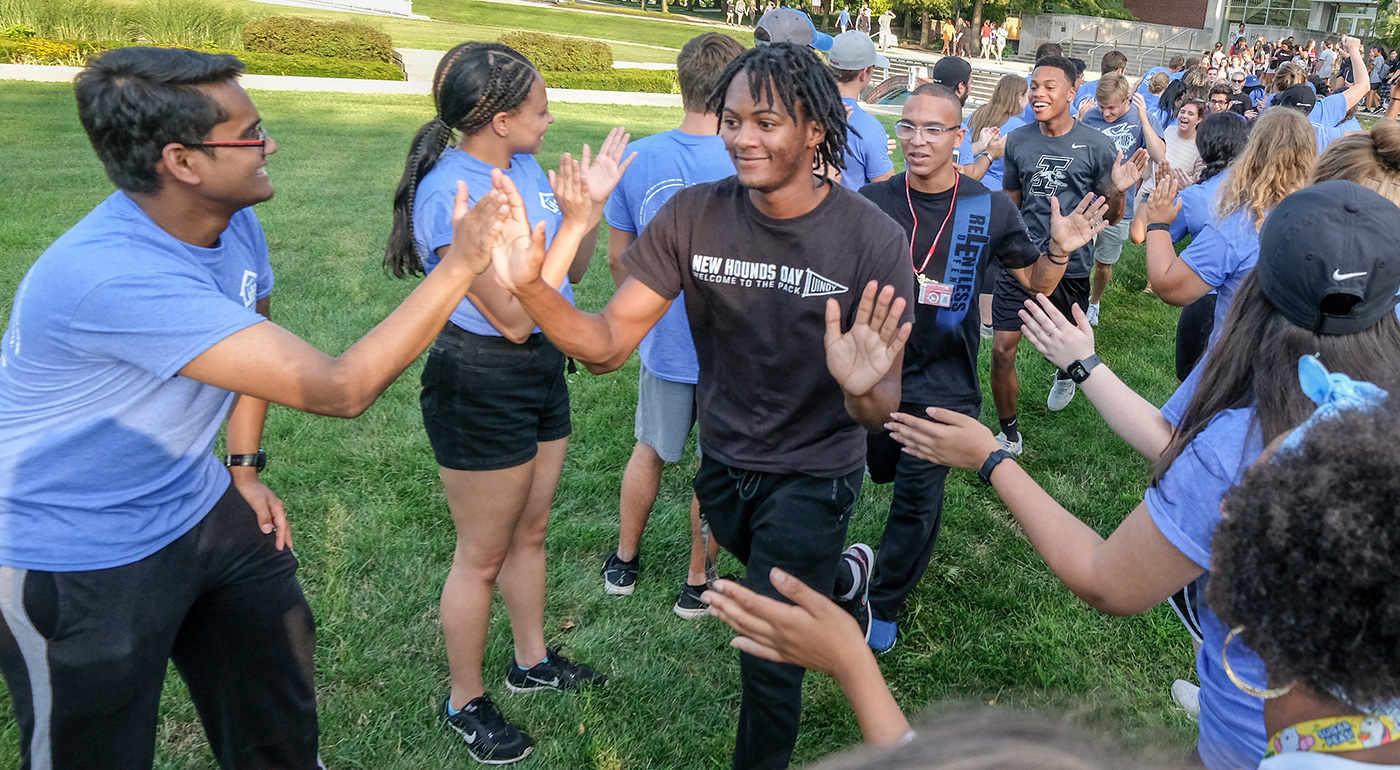 students high-fiving each other