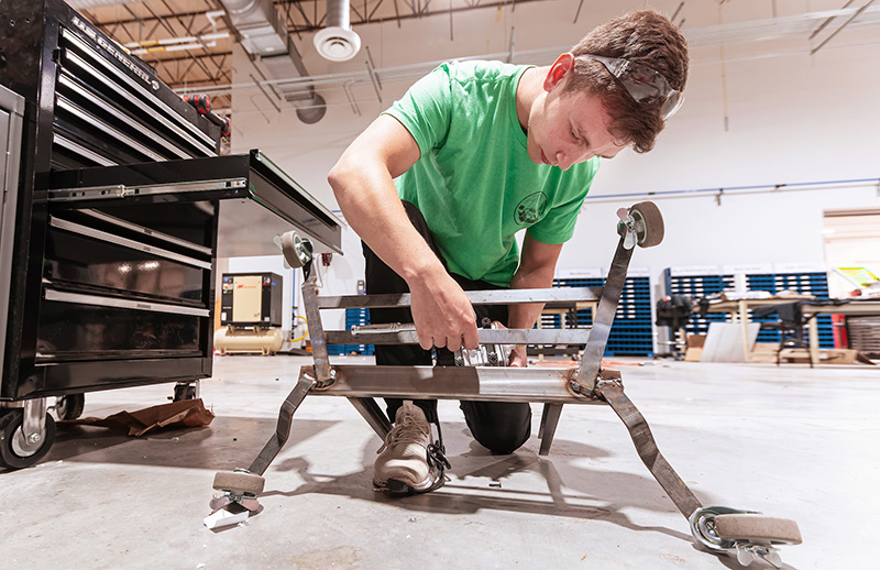 engineering student working on a metal structure