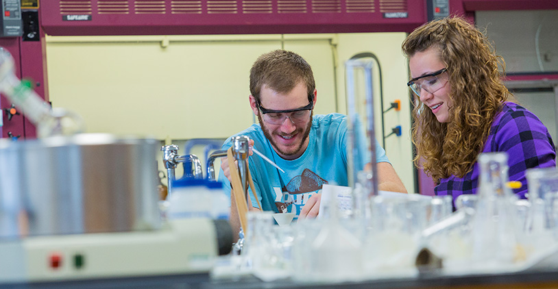 students in a science lab with protective goggles