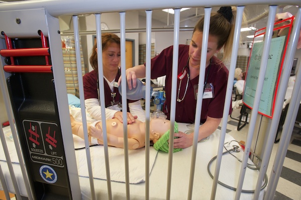 Nursing students with baby simulation mannequin.