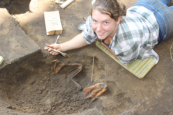 student excavating a pig burial