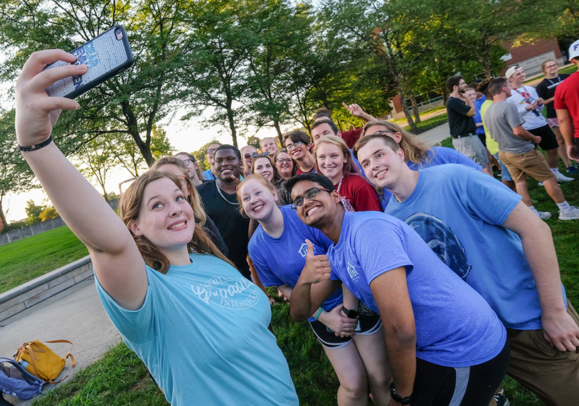new UIndy students taking a group selfie together